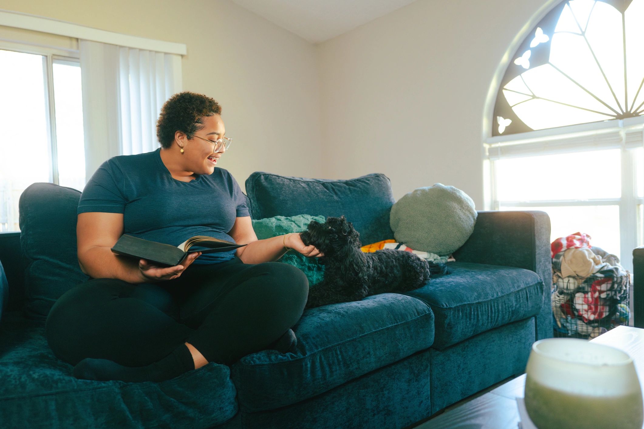 Woman reading with her dog at home